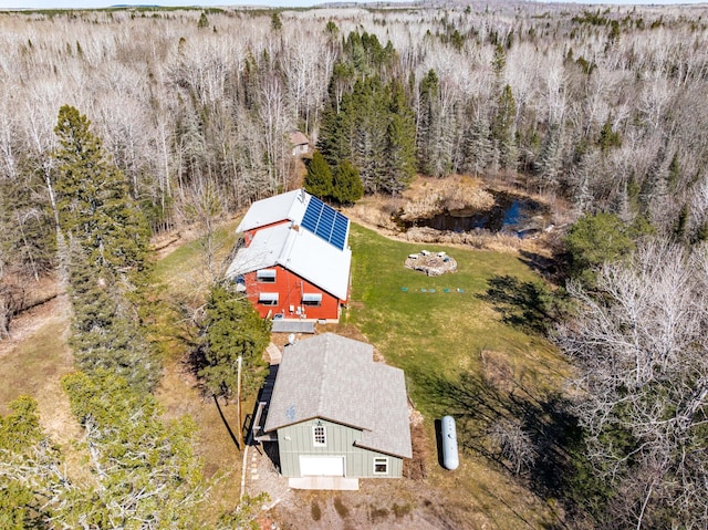 view of subject property with a heavily wooded area