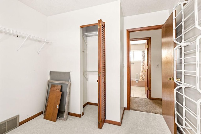 walk in closet featuring visible vents and carpet flooring