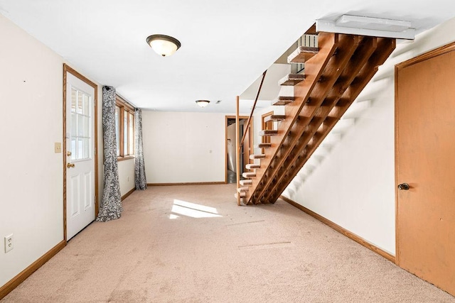 interior space with stairway and baseboards