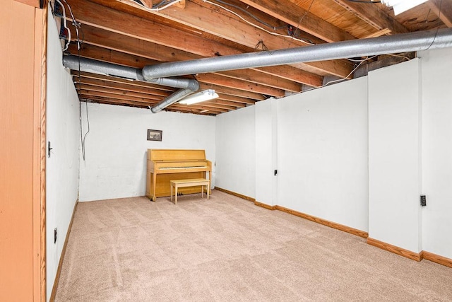 finished basement featuring baseboards and carpet