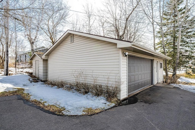 view of snow covered exterior with a garage