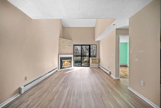 unfurnished living room featuring a glass covered fireplace, wood finished floors, and a baseboard radiator