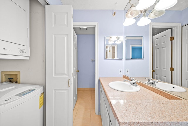 bathroom featuring visible vents, a chandelier, stacked washing maching and dryer, tile patterned floors, and vanity