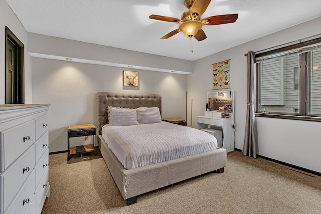 bedroom featuring ceiling fan, baseboards, visible vents, and light carpet