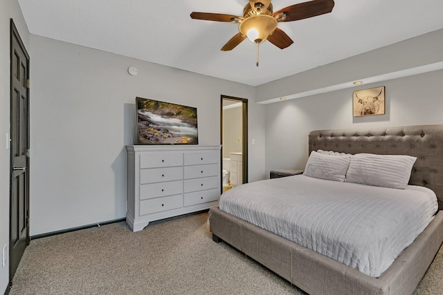 bedroom featuring connected bathroom, baseboards, carpet, and ceiling fan