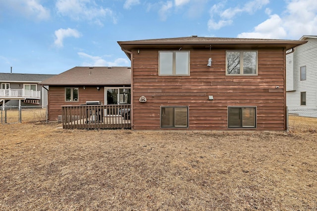 rear view of property with fence