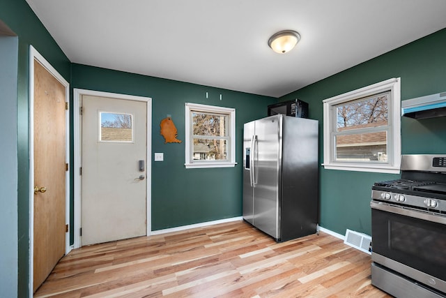 kitchen featuring light wood-style flooring, a healthy amount of sunlight, visible vents, and appliances with stainless steel finishes