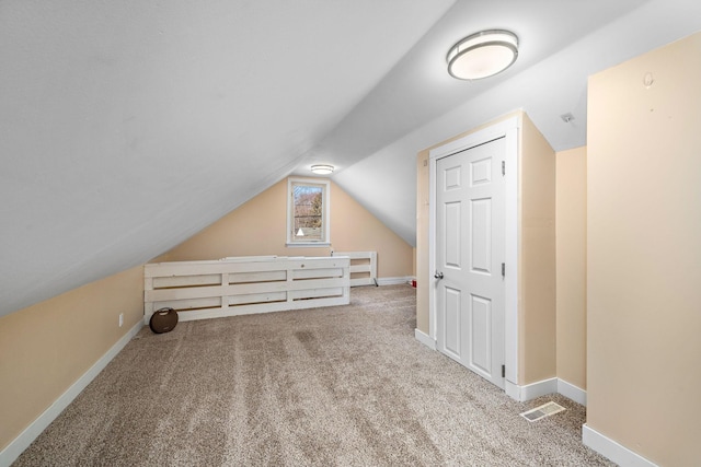 bonus room with visible vents, baseboards, carpet, and vaulted ceiling