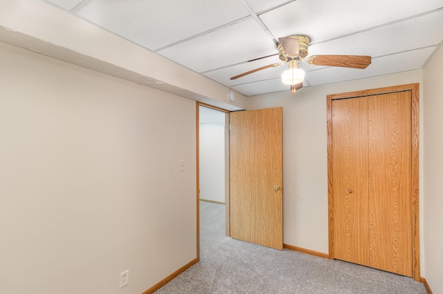 unfurnished bedroom with carpet flooring, a ceiling fan, baseboards, and a closet