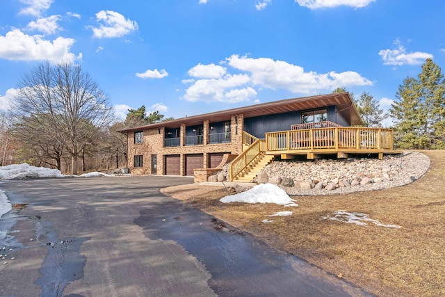 view of front facade with aphalt driveway and an attached garage