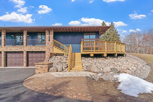 view of front of home featuring stairway, driveway, and an attached garage