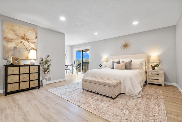 bedroom with wood finished floors, baseboards, recessed lighting, a textured ceiling, and access to outside