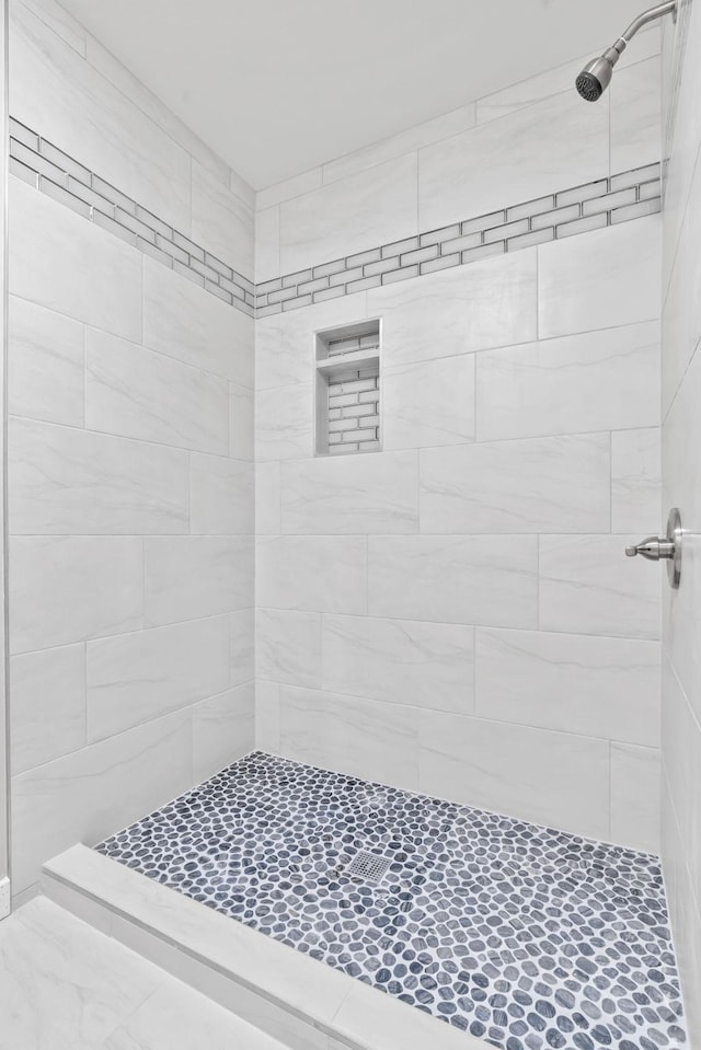 bathroom with a tile shower