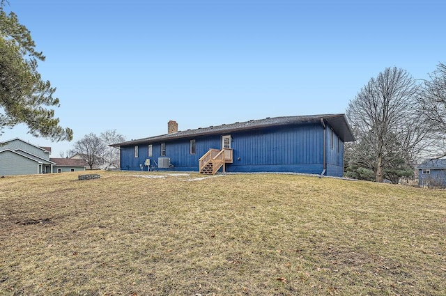 view of front of property featuring a front lawn and a chimney