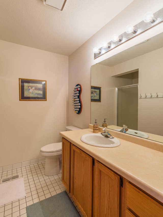 bathroom with vanity, tile patterned flooring, an enclosed shower, a textured ceiling, and toilet