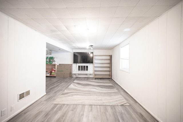 unfurnished living room with visible vents and wood finished floors