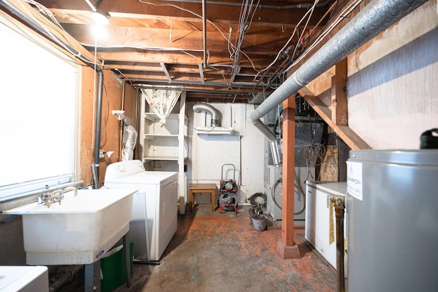 basement featuring water heater, washer / dryer, and a sink