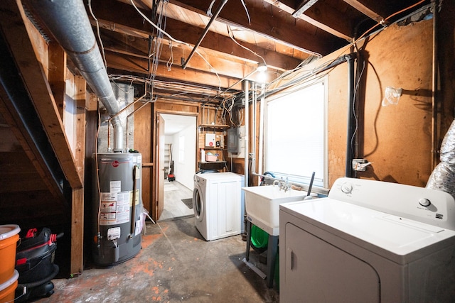 basement featuring gas water heater, electric panel, independent washer and dryer, and a sink