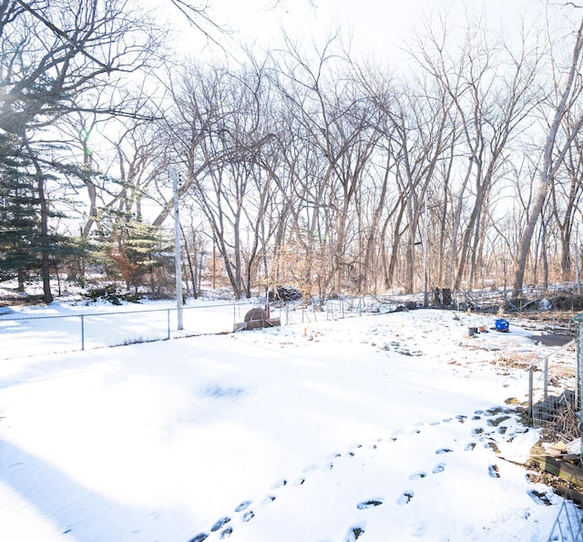 yard covered in snow with fence