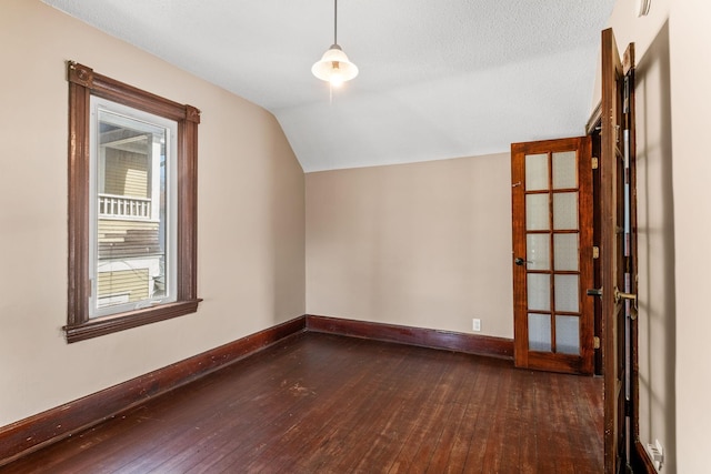 bonus room with dark wood finished floors, lofted ceiling, baseboards, and a textured ceiling