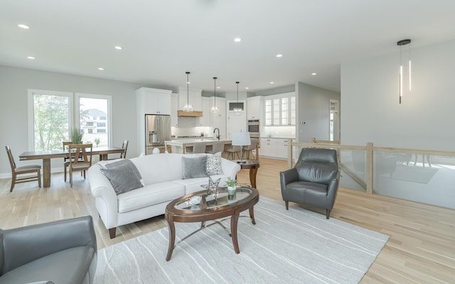 living area with recessed lighting and light wood-type flooring