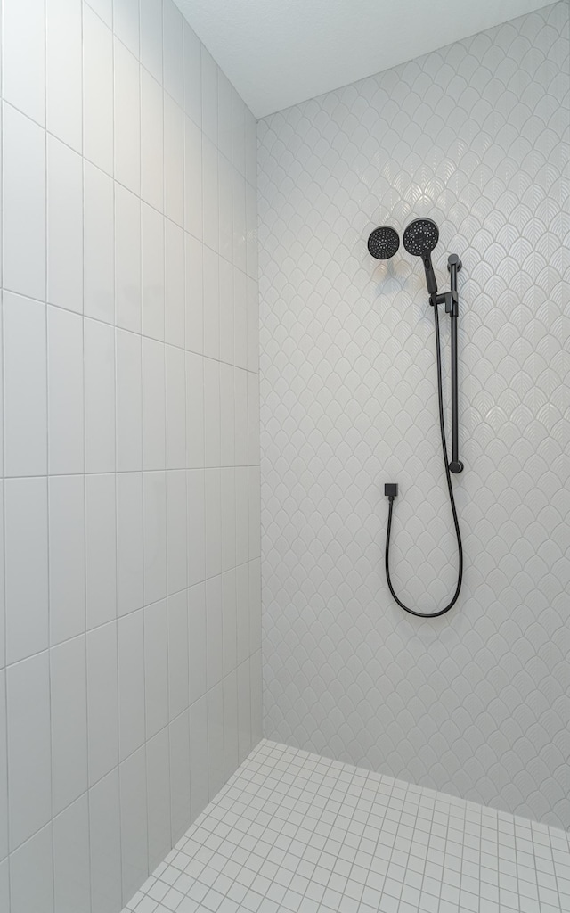 bathroom with tiled shower