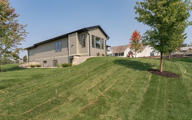 view of home's exterior with a lawn