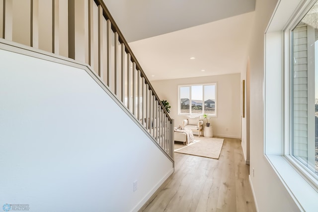 entrance foyer with recessed lighting, stairway, light wood-style flooring, and baseboards