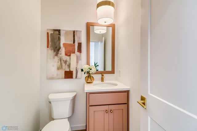 half bathroom featuring toilet and vanity