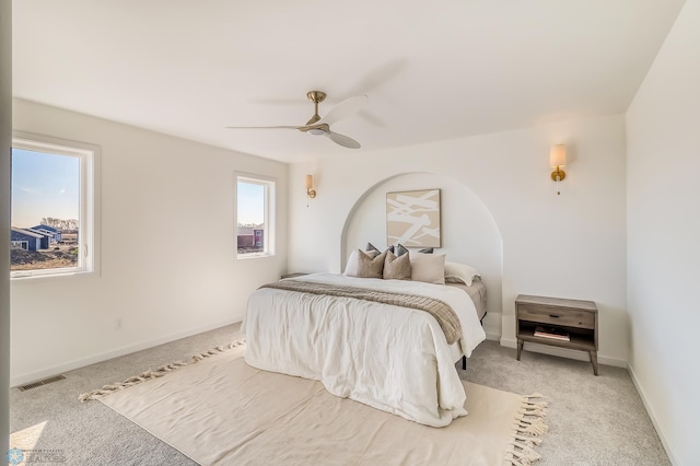 bedroom with visible vents, baseboards, a ceiling fan, and carpet flooring