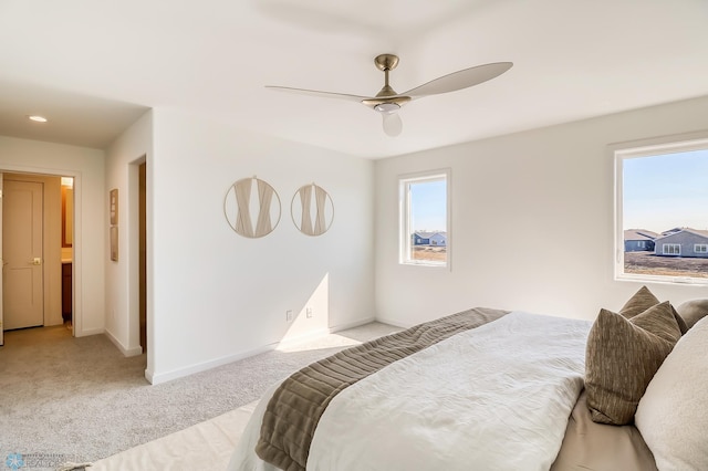 bedroom featuring ceiling fan, baseboards, and light carpet