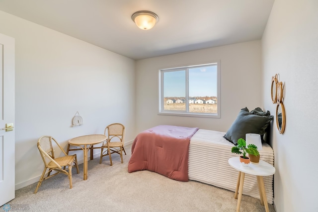 carpeted bedroom featuring baseboards