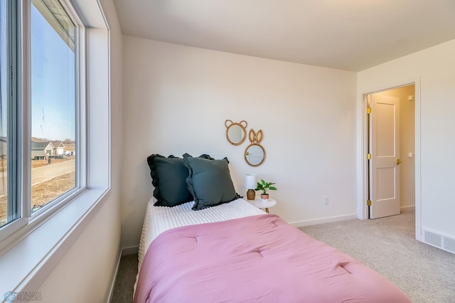 carpeted bedroom featuring visible vents and baseboards