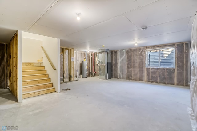 basement with stairway, heating unit, and electric water heater