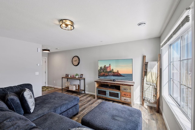 living area with wood finished floors and baseboards