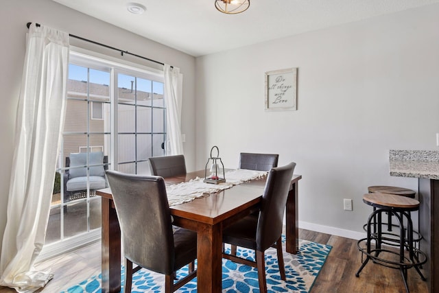 dining room with baseboards and wood finished floors