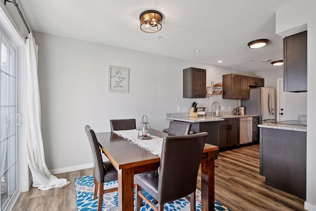 dining room featuring recessed lighting, baseboards, and dark wood-style floors