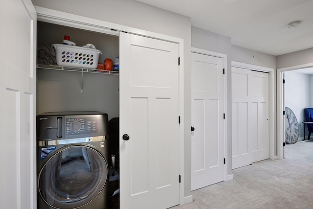 washroom with laundry area, carpet flooring, washer / clothes dryer, and a barn door