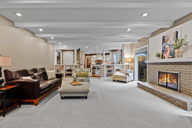 carpeted living area featuring recessed lighting, beam ceiling, and a fireplace