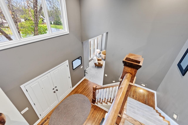 interior space featuring a high ceiling, wood finished floors, and baseboards