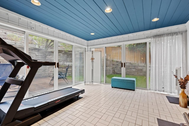 interior space featuring wooden ceiling, recessed lighting, and brick floor