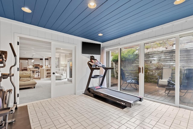 exercise room featuring recessed lighting, brick floor, and wooden ceiling