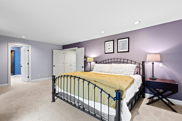 bedroom featuring recessed lighting, light colored carpet, and baseboards