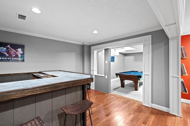 recreation room with pool table, crown molding, and wood finished floors