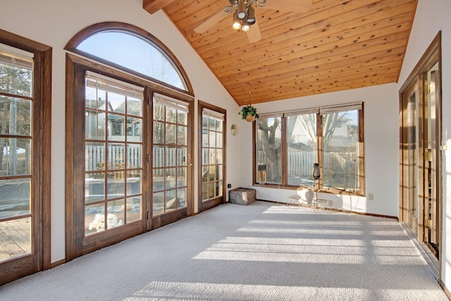 sunroom / solarium featuring lofted ceiling, a ceiling fan, and wooden ceiling