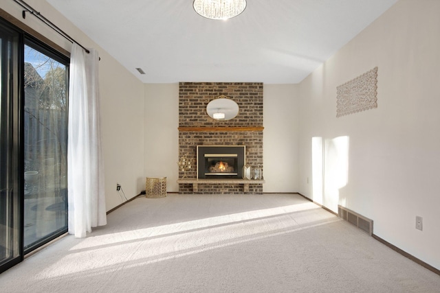 unfurnished living room featuring visible vents, carpet flooring, a fireplace, and baseboards