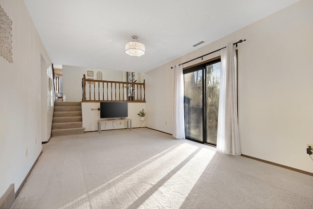 unfurnished living room featuring visible vents, stairway, carpet, and baseboards