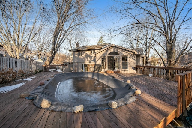 wooden terrace with fence and a hot tub