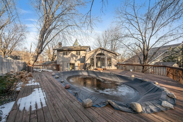 wooden deck with fence and a hot tub