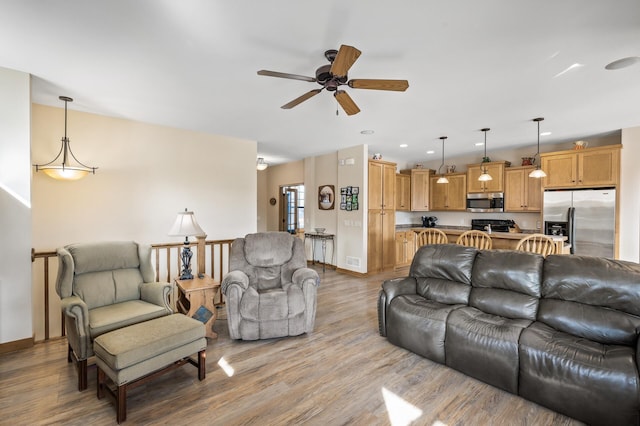 living area with light wood finished floors, recessed lighting, ceiling fan, and baseboards